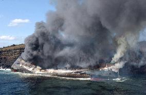 Freighter stranded on Izu-Oshima Island catches fire